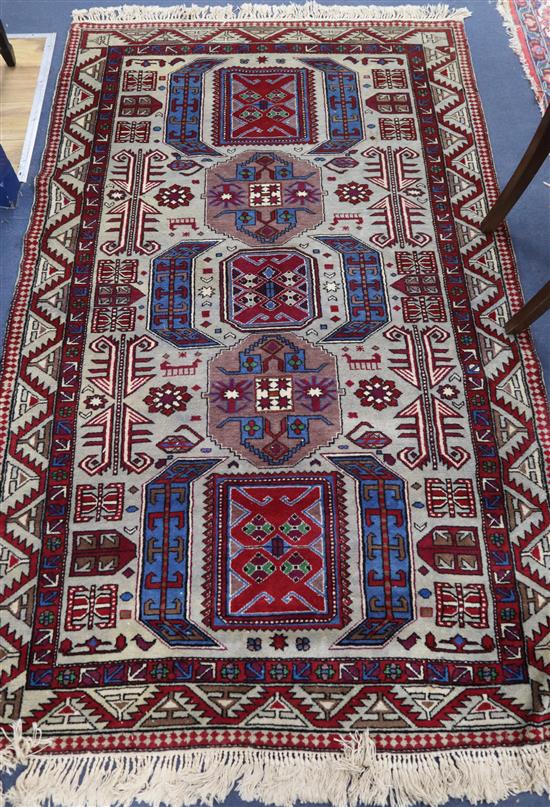 A Caucasian fawn ground rug 210 x 127cm